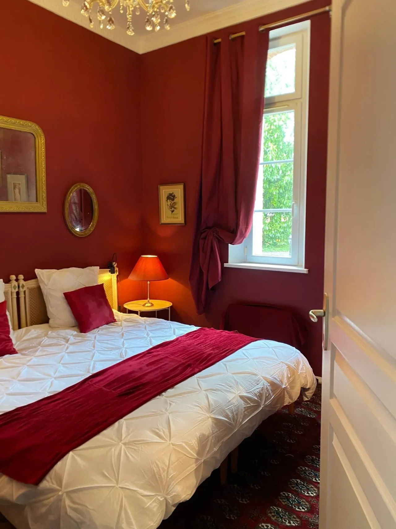 Chambre rouge cosy avec lit double et fenêtre